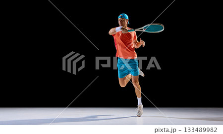Tennis player running forward to return ball with full determination 133489982