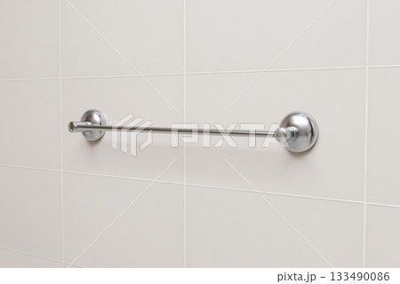 Chrome Towel Bar Mounted on White Bathroom Tile Wall 133490086