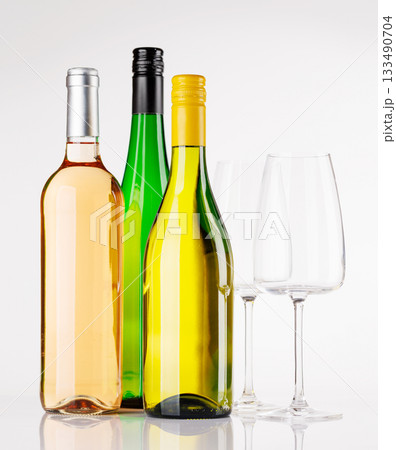 White wine bottle and glasses on white background 133490704