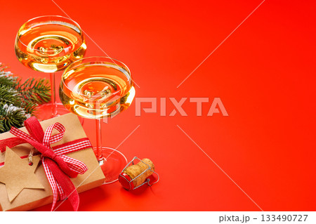 Champagne glasses and snowy fir branches Champagne glasses and snowy fir branches 133490727