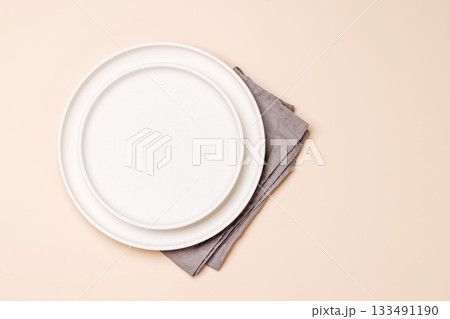 Empty plate on beige background, food mockup with natural light 133491190