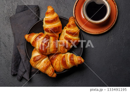 Aromatic croissants in bowl with cup of coffee Aromatic croissants in bowl with cup of coffee 133491195