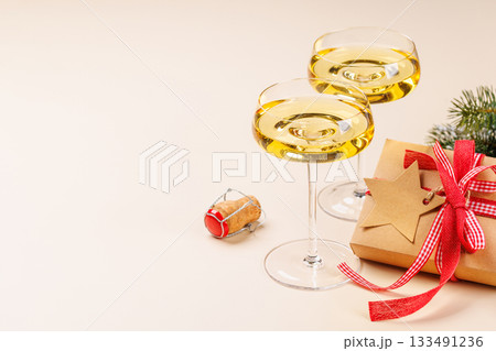 Champagne glasses and snowy fir branches 133491236