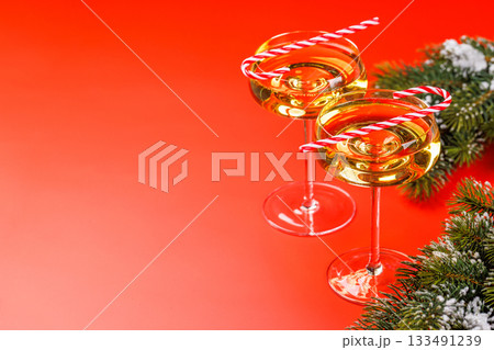 Champagne glasses and snowy fir branches 133491239