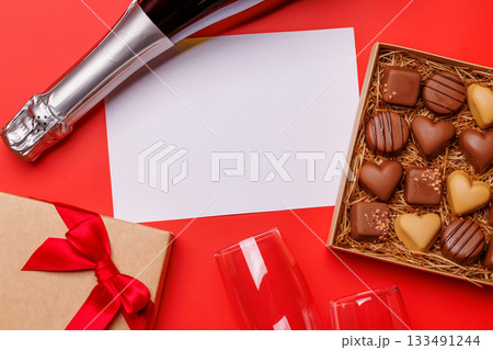 A glasses of champagne elegantly paired with a box of rich chocolates A glasses of champagne elegantly paired with a box of rich chocolates 133491244