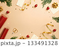 Christmas frame flat lay with red wrapping paper, gold ribbons, scissors, and baubles on beige background. Top view with copy space for text. 133491328