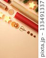 Christmas background with star candles, dried oranges, spices, and wrapping paper on beige background. Copy space for text or design. 133491337