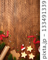 Christmas wrapping background with star candles, wrapping paper, fir spruces, gift tags on wooden desk. Copy space for text or design. 133491339