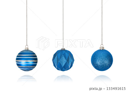 Set of Christmas decorations in form of striped blue ball on string, shiny ball and ball with geometric pattern isolated on white background with clipping path. Design element for Christmas card Set of Christmas decorations in form of striped blue ball on string, shiny ball and ball with geometric pattern isolated on white background with clipping path. Design element for Christmas card 133491615