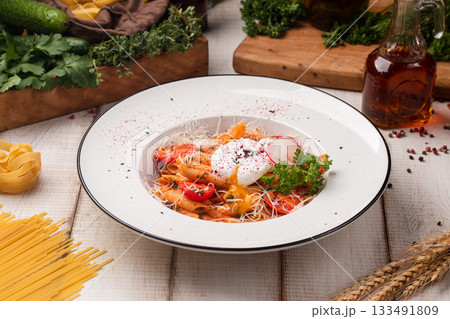 Spicy penne arrabbiata with poached egg 133491809