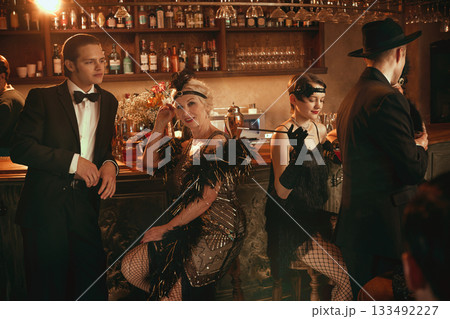 Retro bar moment with glamorous women posing confidently in vintage outfits 133492227