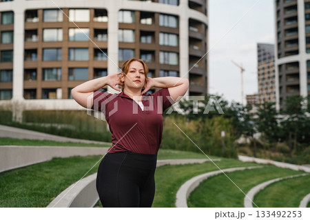Body positive woman warming up before training. Body positive woman warming up before training. 133492253