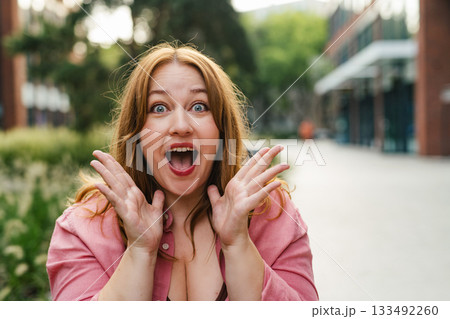 Surprised beautiful curvy woman in park. 133492260
