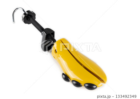 Shoe stretcher with turning mechanism toe plugs. Tool for adjusting shoe size on white background. 133492349
