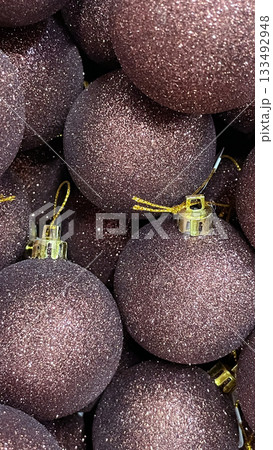 Heap of dark mauve glitter Christmas baubles close up. Festive holiday abstract background texture Heap of dark mauve glitter Christmas baubles close up. Festive holiday abstract background texture 133492948