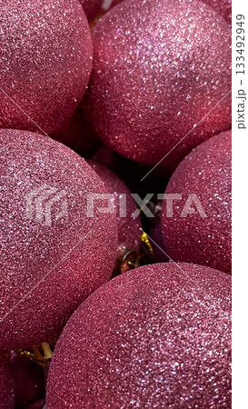 Heap of vibrant pink glitter Christmas baubles close up. Festive holiday abstract background texture Heap of vibrant pink glitter Christmas baubles close up. Festive holiday abstract background texture 133492949