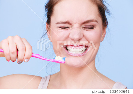 Woman brushing cleaning teeth 133493641