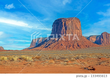 Monument Valley desert butte under blue sky 133493813