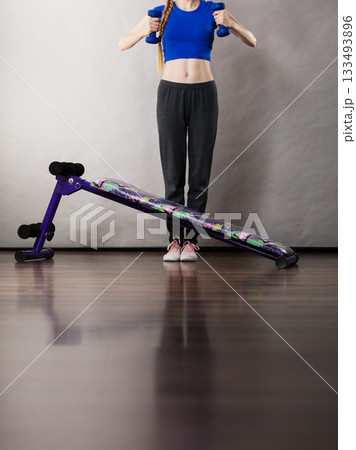 Woman legs behind sit ups bench 133493896