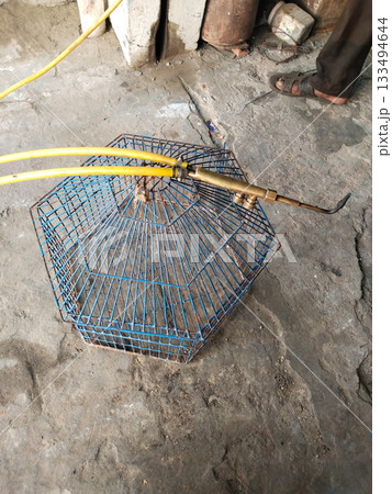 preparation for welding cage of rabbit with gas torch 133494644