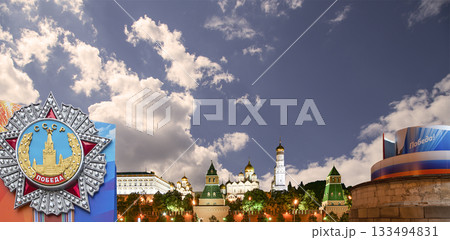 Moscow Kremlin (with decorations for the holiday of May 9 in honor of Victory Day celebration (WWII). Against the sky with clouds, Russia. TRANSLATION: USSR, Victory! 133494831