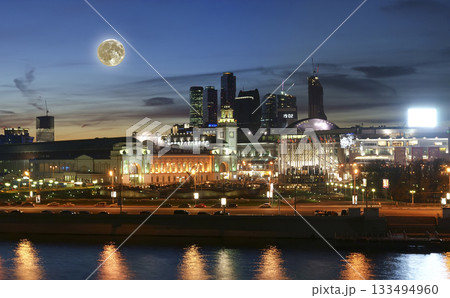 Moscow, Russia. Panoramic view from the embankment of the Moskva River (at night with the super moon). English translation from Russian: Kievsky train station 133494960