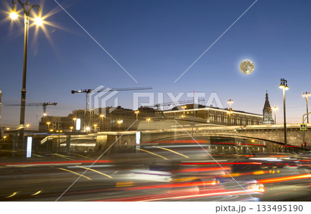 Night traffic on the Moskvoretskaya Embankment near the park Zaryadye (with the super moon), Moscow, Russia 133495190