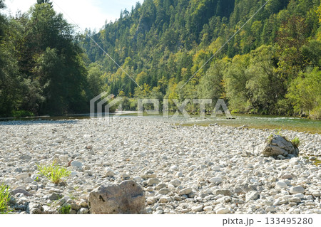 Wide Rocky Riverbed in the Alps on a Sunny Day Wide Rocky Riverbed in the Alps on a Sunny Day 133495280