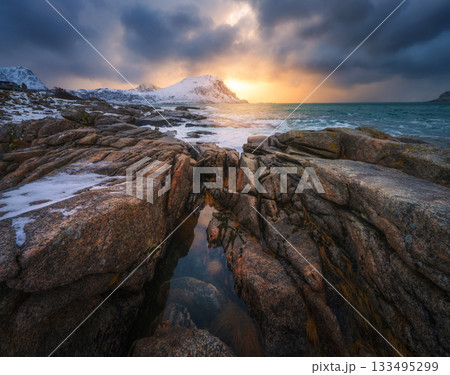 Rock pools and snowy mountains on the Lofoten coast, Norway Rock pools and snowy mountains on the Lofoten coast, Norway 133495299