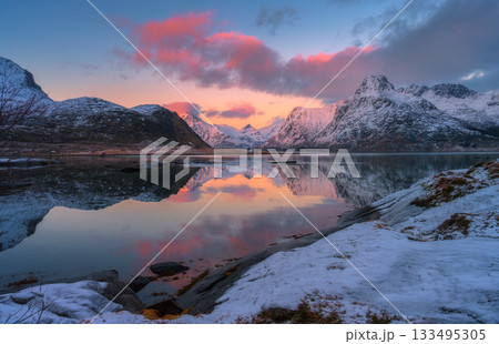 Winter landscape with sea, pink sky, rorbu, rocks in snow Winter landscape with sea, pink sky, rorbu, rocks in snow 133495305