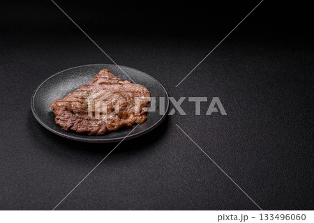 Grilled beef steak, meat cooked on barbecue with salt and pepper. Grilled beef steak Grilled beef steak, meat cooked on barbecue with salt and pepper. Grilled beef steak 133496060