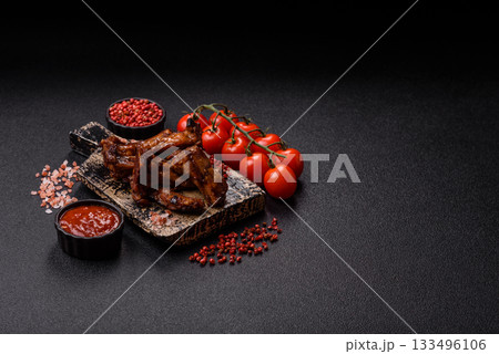 Grilled beef or pork ribs, meat cooked on a barbecue with salt and pepper. Grilled ribs Grilled beef or pork ribs, meat cooked on a barbecue with salt and pepper. Grilled ribs 133496106