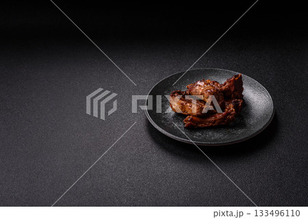 Grilled beef or pork ribs, meat cooked on a barbecue with salt and pepper. Grilled ribs Grilled beef or pork ribs, meat cooked on a barbecue with salt and pepper. Grilled ribs 133496110