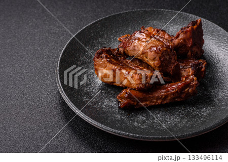 Grilled beef or pork ribs, meat cooked on a barbecue with salt and pepper. Grilled ribs 133496114