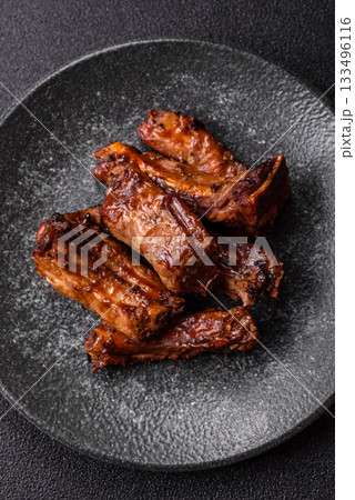 Grilled beef or pork ribs, meat cooked on a barbecue with salt and pepper. Grilled ribs Grilled beef or pork ribs, meat cooked on a barbecue with salt and pepper. Grilled ribs 133496116