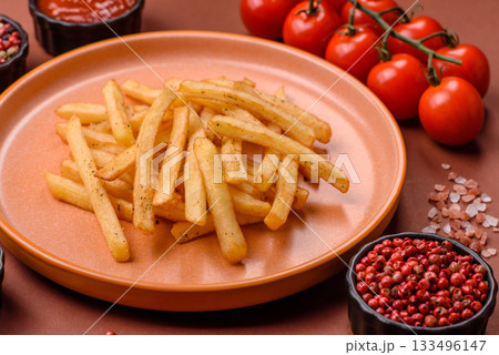Crispy French fries with sauce, fast food, snack or chips. French fries, takeaway food 133496147
