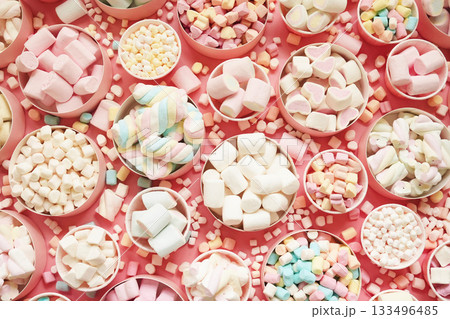 Confectionery and sweeties varieties background: light pink and white marshmallows, sugar confetti and candies, selective focus 133496485