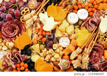 Halloween charcuterie board fun food mix: ghosts, mummies, pumpkins, eyes, brooms. Party spooky salty snacks Halloween charcuterie board fun food mix: ghosts, mummies, pumpkins, eyes, brooms. Party spooky salty snacks 133496487