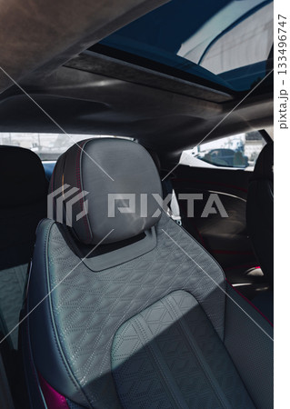 Close-up view of modern car interior with stylish seat and sunroof 133496747