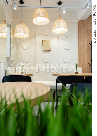 Elegant cafe interior with soft lighting and simple decor in a cozy setting Elegant cafe interior with soft lighting and simple decor in a cozy setting 133496749