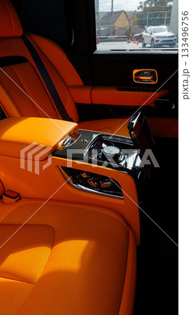 Luxury car interior featuring bright orange seats and sleek design details Luxury car interior featuring bright orange seats and sleek design details 133496756