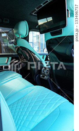 Luxury car interior with turquoise leather seats and modern technology visible Luxury car interior with turquoise leather seats and modern technology visible 133496757