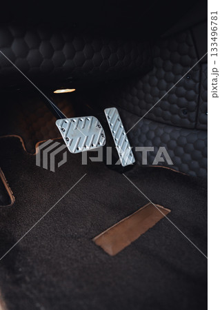 Close view of car pedals showing modern design and sleek materials in a stylish interior 133496781