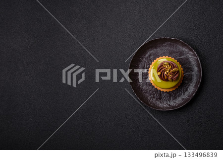 Pistachio cake or tart topped with green mousse with nuts and fruit filling. Pistachio pie Pistachio cake or tart topped with green mousse with nuts and fruit filling. Pistachio pie 133496839