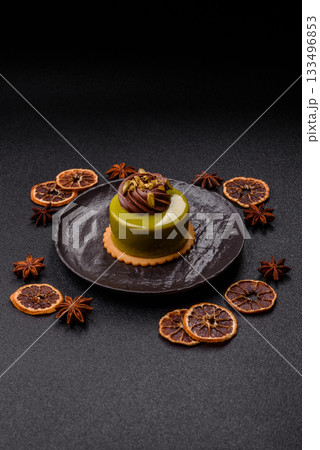 Pistachio cake or tart topped with green mousse with nuts and fruit filling. Pistachio pie Pistachio cake or tart topped with green mousse with nuts and fruit filling. Pistachio pie 133496853