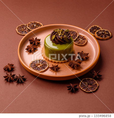Pistachio cake or tart topped with green mousse with nuts and fruit filling. Pistachio pie Pistachio cake or tart topped with green mousse with nuts and fruit filling. Pistachio pie 133496858