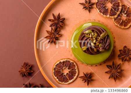 Pistachio cake or tart topped with green mousse with nuts and fruit filling. Pistachio pie 133496860