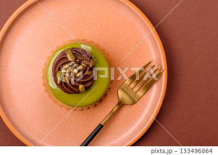 Pistachio cake or tart topped with green mousse with nuts and fruit filling. Pistachio pie Pistachio cake or tart topped with green mousse with nuts and fruit filling. Pistachio pie 133496864