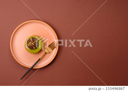 Pistachio cake or tart topped with green mousse with nuts and fruit filling. Pistachio pie Pistachio cake or tart topped with green mousse with nuts and fruit filling. Pistachio pie 133496867