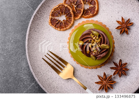 Pistachio cake or tart topped with green mousse with nuts and fruit filling. Pistachio pie Pistachio cake or tart topped with green mousse with nuts and fruit filling. Pistachio pie 133496875
